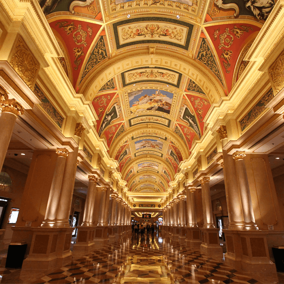 A wide view of an incredible ceiling paintings inside a huge hotel lobby.