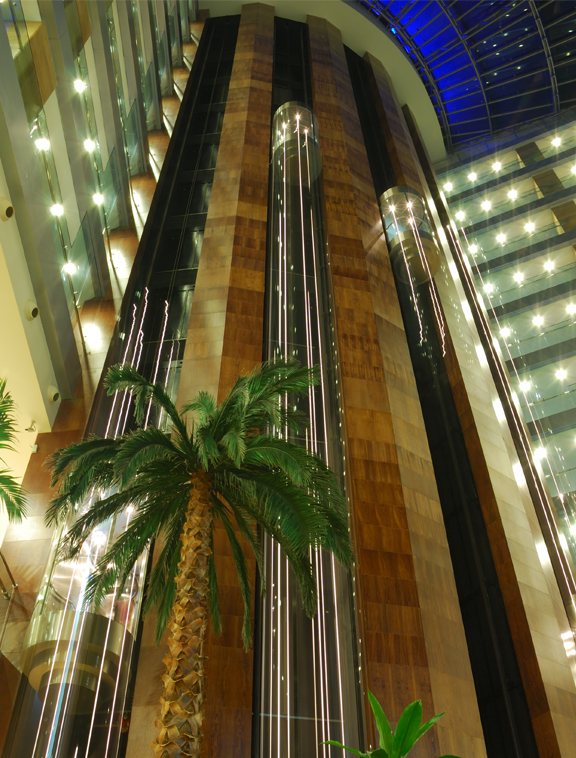 A high-angle shot of a tall elevator shaft inside a hotel building.